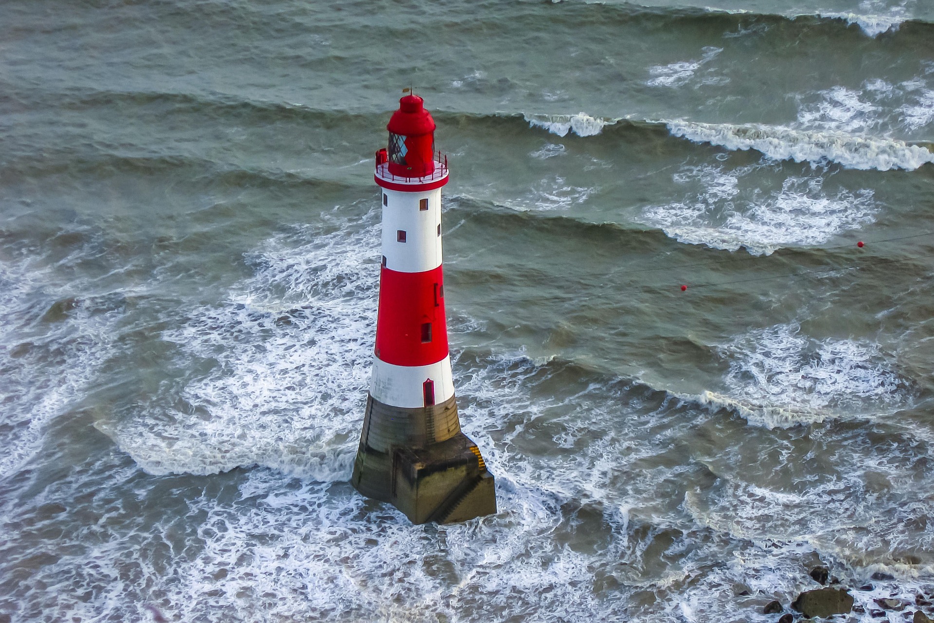 Lighthouse standing firm against the sea, symbolizing steady guidance