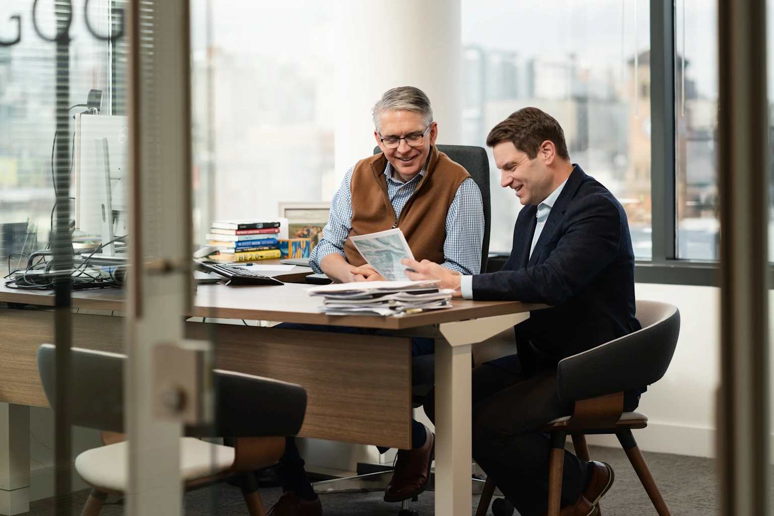 Two colleagues reviewing documents in an office